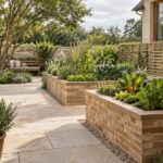 Contemporary kitchen garden with stone paths, raised planting beds, sheltered working area, and a mature courtyard tree.